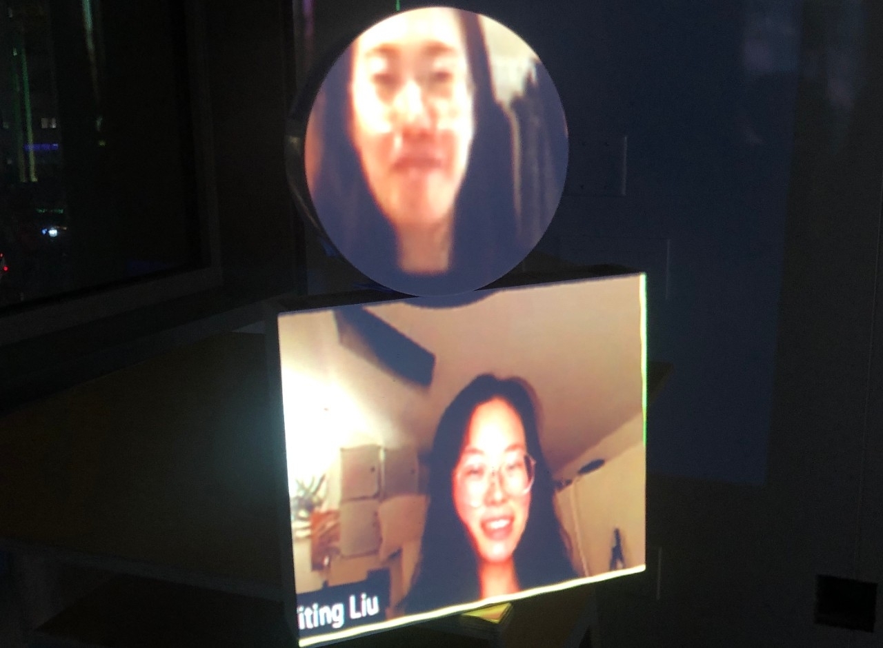 Students images are projected onto objects in the room