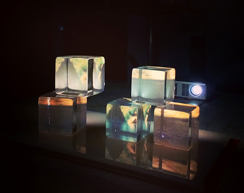 glass cubes stacked up with a projected image on them