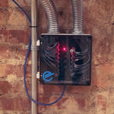 an electrical panel in a brick wall