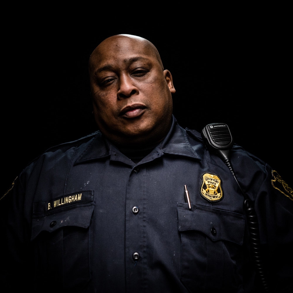 Portrait of a police officer against a black bacground