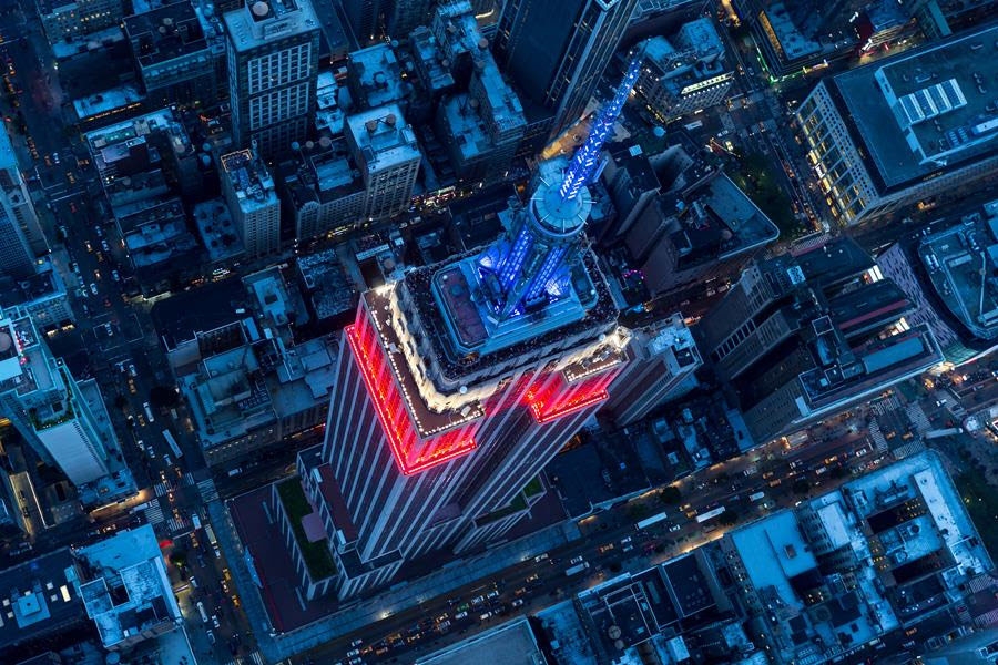 The Empire State Building with red, white and blue lights taken from up above