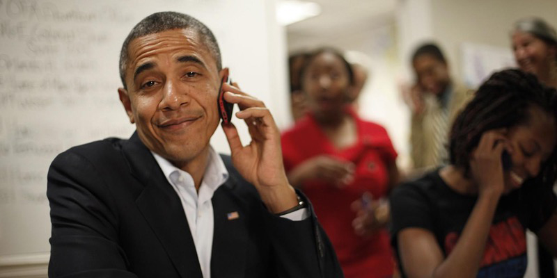 President Obama on a mobile phone smirking at the camera