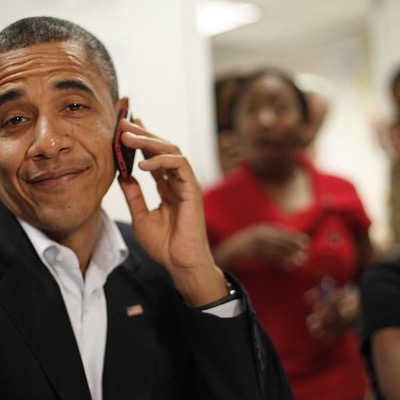 President Obama on a mobile phone smirking at the camera