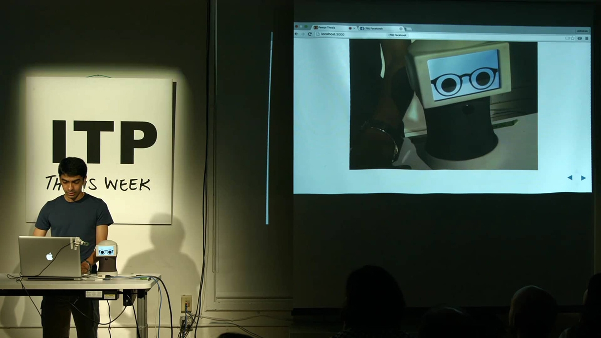 a man at a laptop giving a presentation bringing to life a mini computer with glasses and eyes
