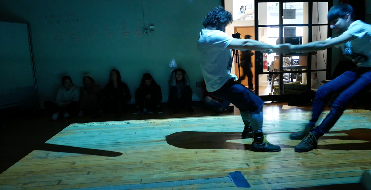 Two people trying to pull away from each other