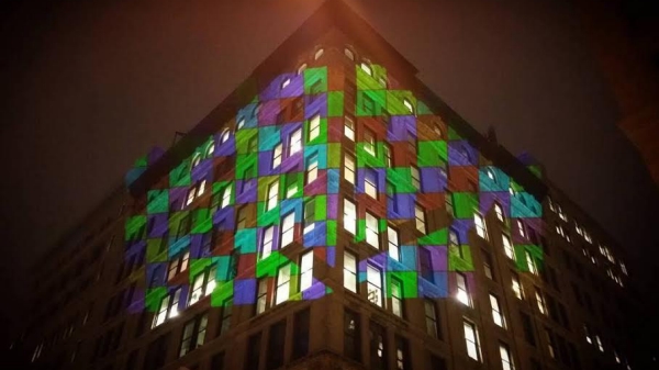 A building with colors projected onto the windows