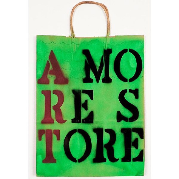 a bag painted green with "A More Store" spraypainted on it