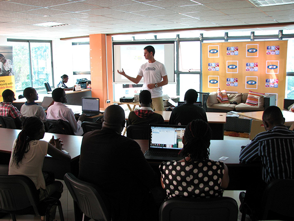 a man giving a lecture in front of a classroom of students