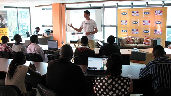 a man giving a lecture in front of a classroom of students