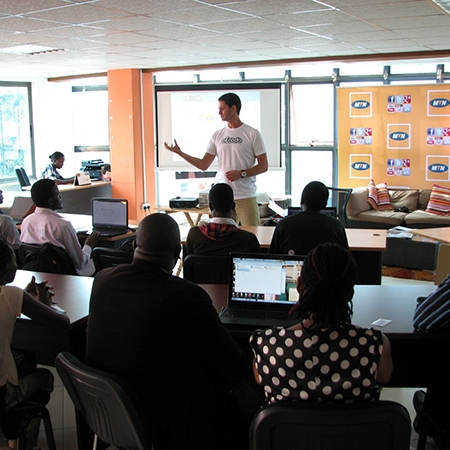 a man giving a lecture in front of a classroom of students