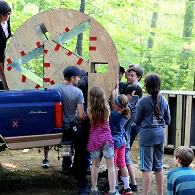 Children unloading truck with equipment in the outdoors