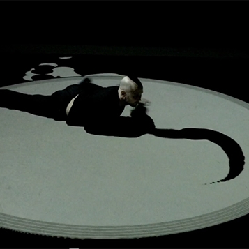 A person laying within a circle with a projected shape emanating out