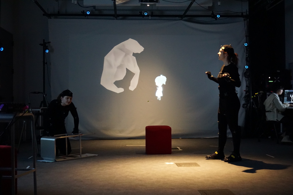 Photo of two people interacting with 3D projection; photo by Christina Hall