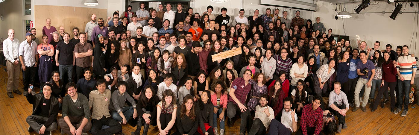 a group shot of all 100+ students in the lounge