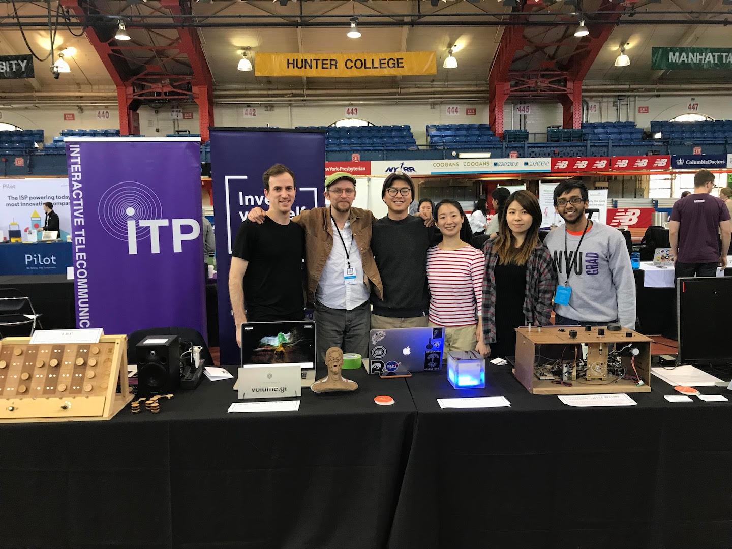 NYC CS Fair table booth with ITP students in front of physical computing projects