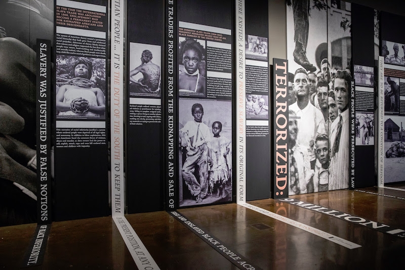 The Legacy Museum: From Enslavement to Mass Incarceration, image of the inside of the museum showing photographs of lynching