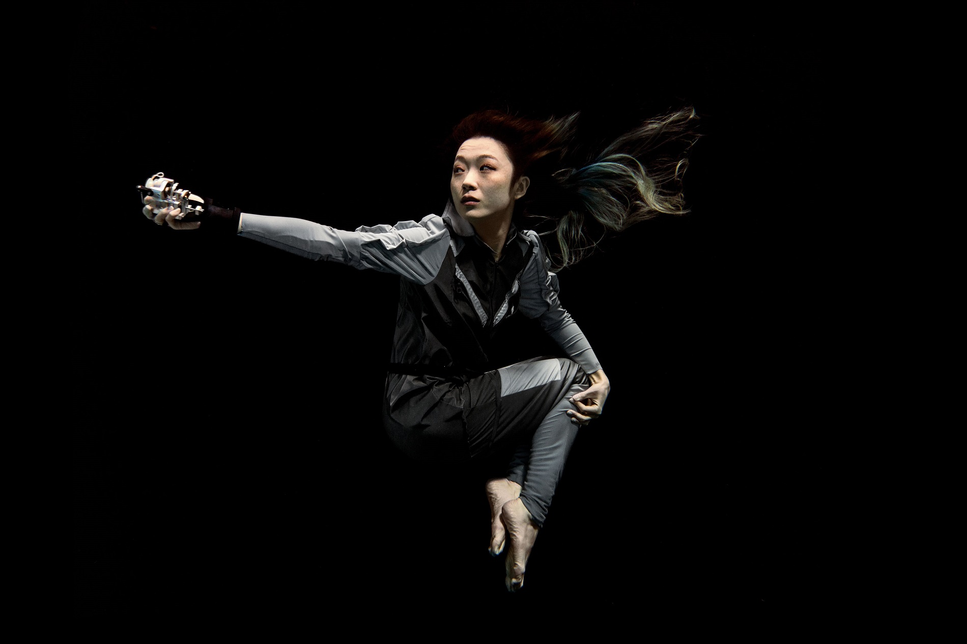 Image of Xin Liu floating in space.