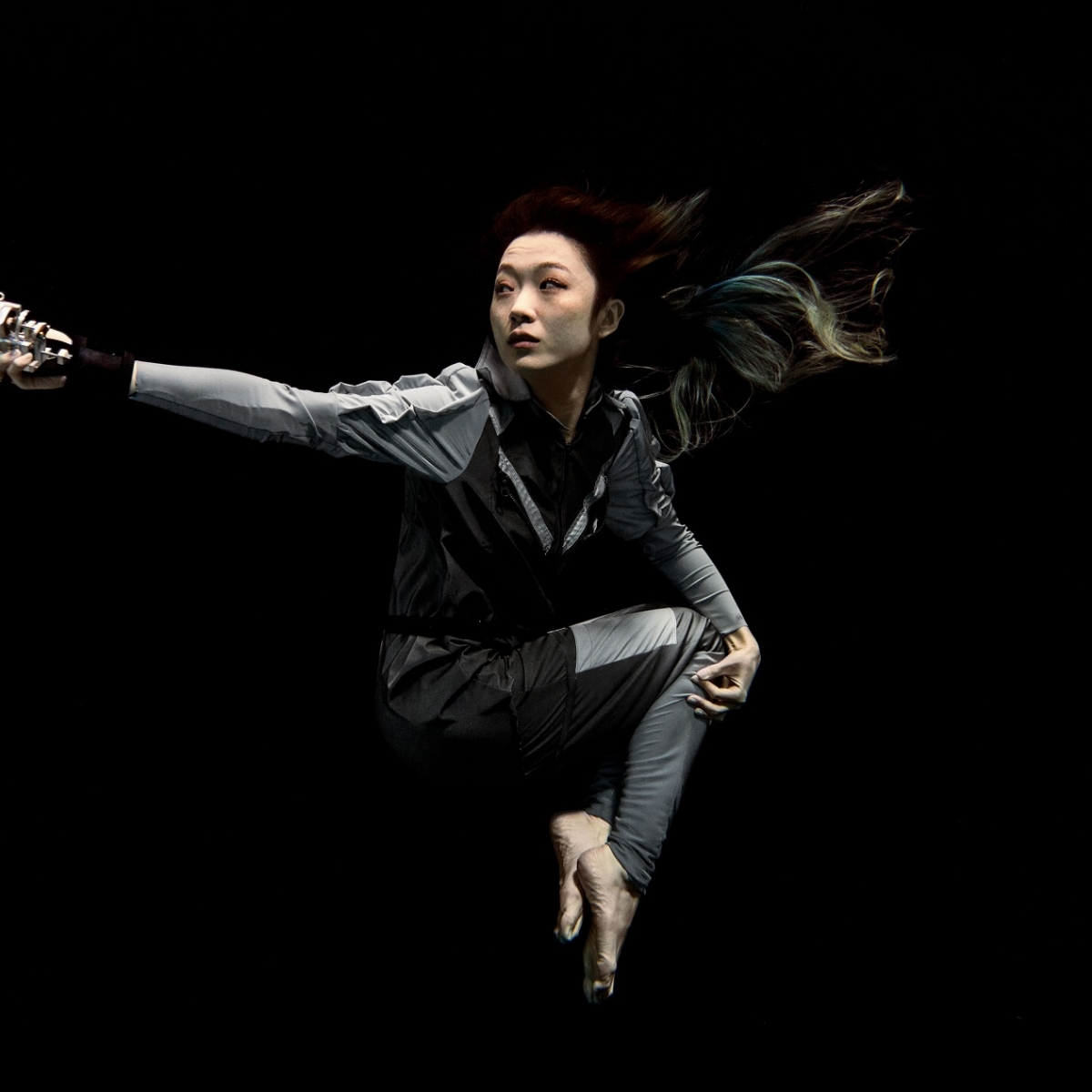 Image of Xin Liu floating in space.