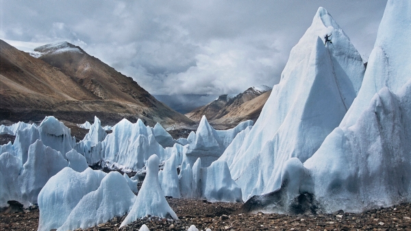 Man climbs a melting glacier
