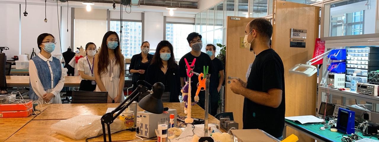a group of students wearing masks in a maker space lab