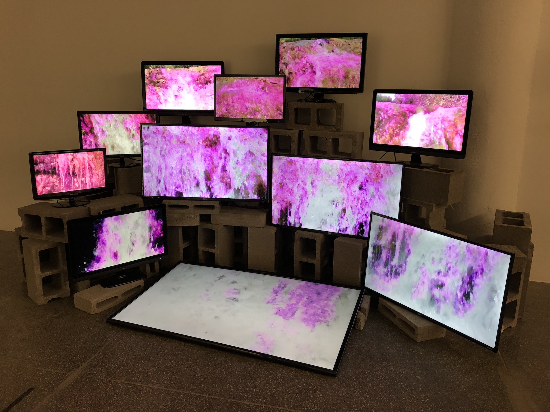 Multi computer Screens with pink and grey wallpaper