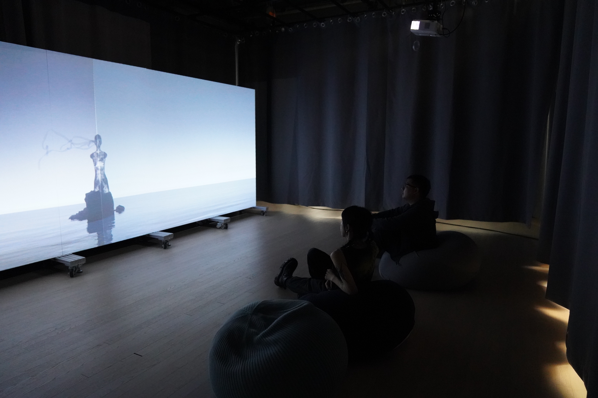 People sitting in front of a projection screen