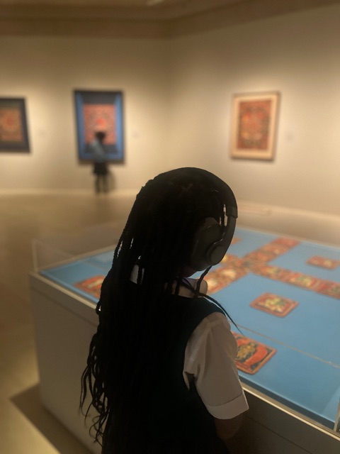 person in front of art