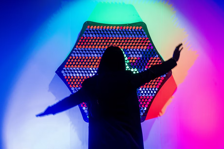 woman standing in front of colorful mirrror
