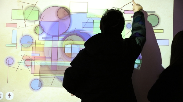graphic shapes projected with a person drawing his own shape