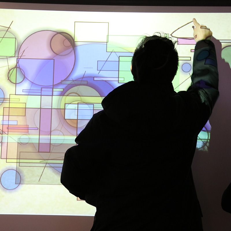 graphic shapes projected with a person drawing his own shape