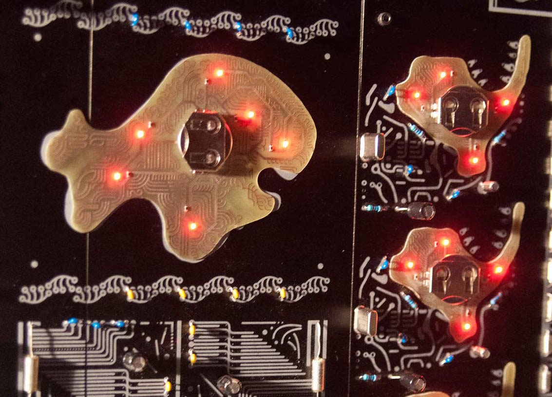 circuit boards in animal shapes lit up with LED's