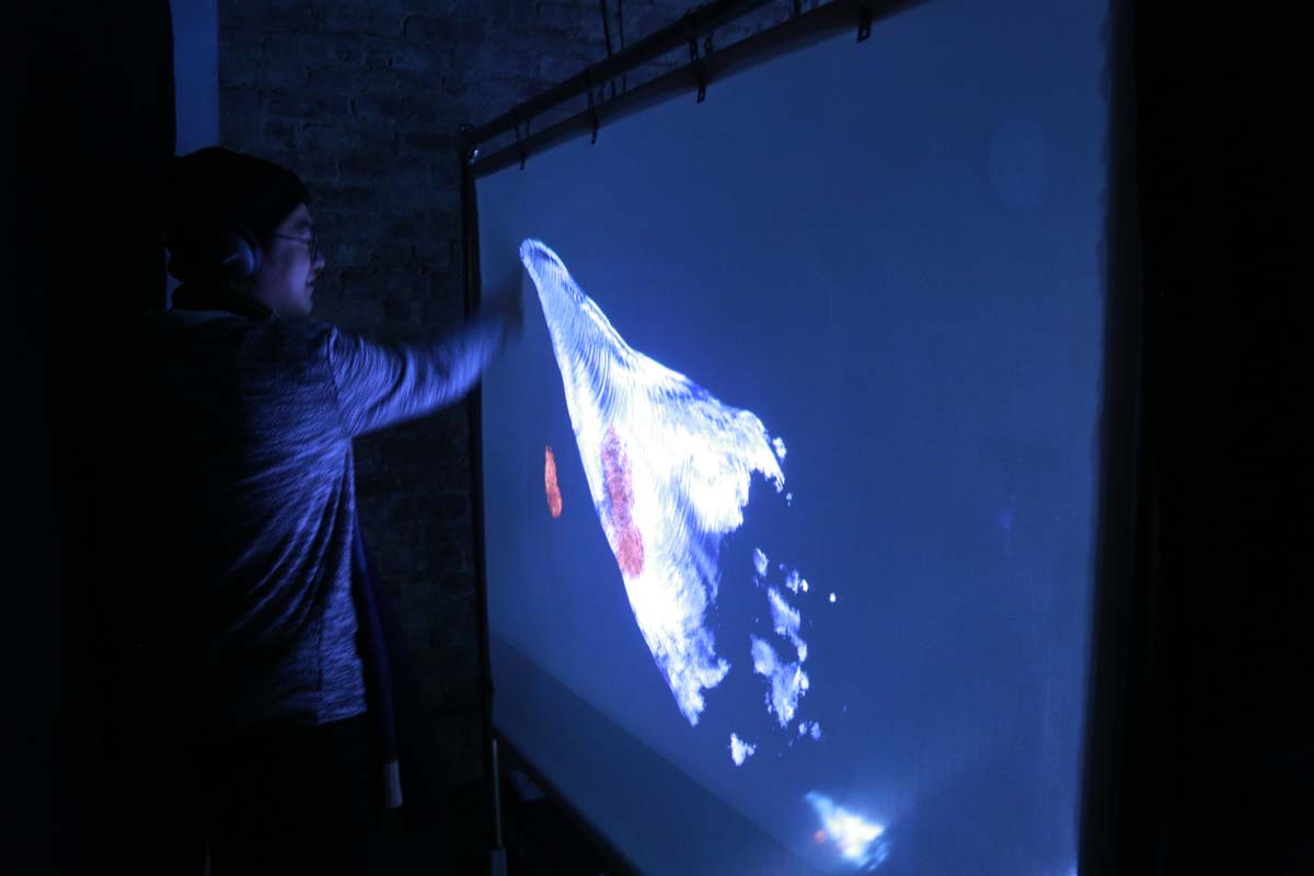 a man creates a ripple on the screen based on his movement