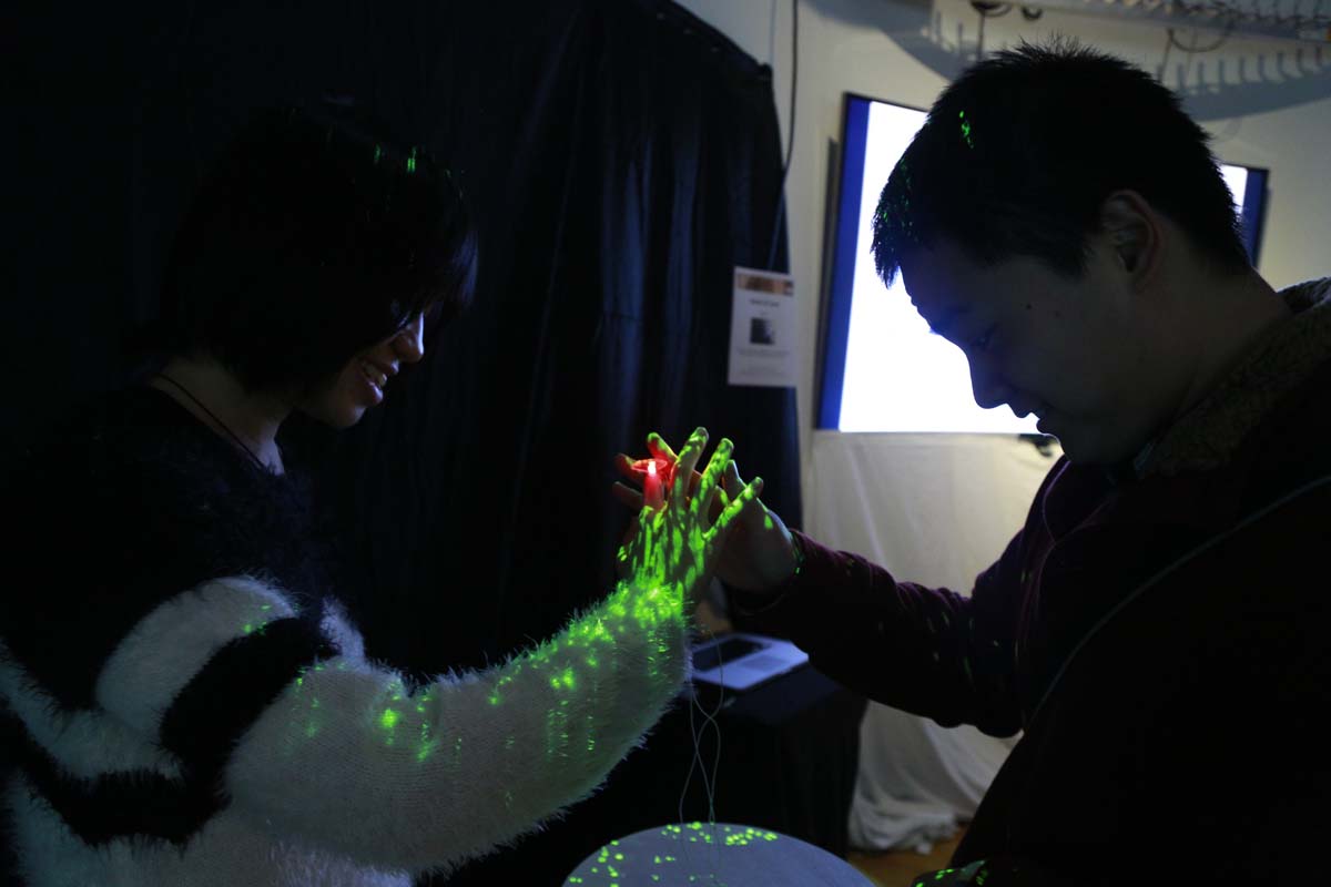 two people touching hands that trigger lights to turn on