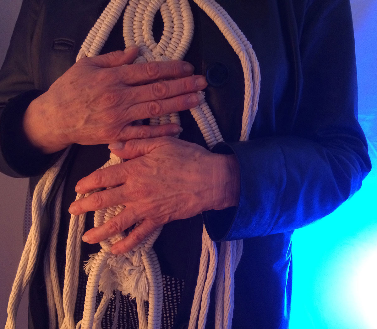 a person clutching a crocheted rope