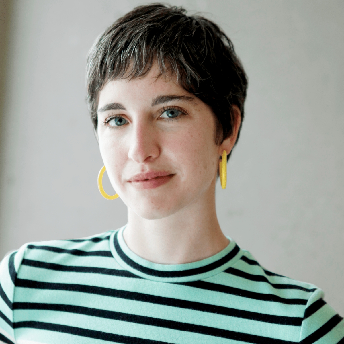 Emily Hoffman in hoop earrings and a striped shirt