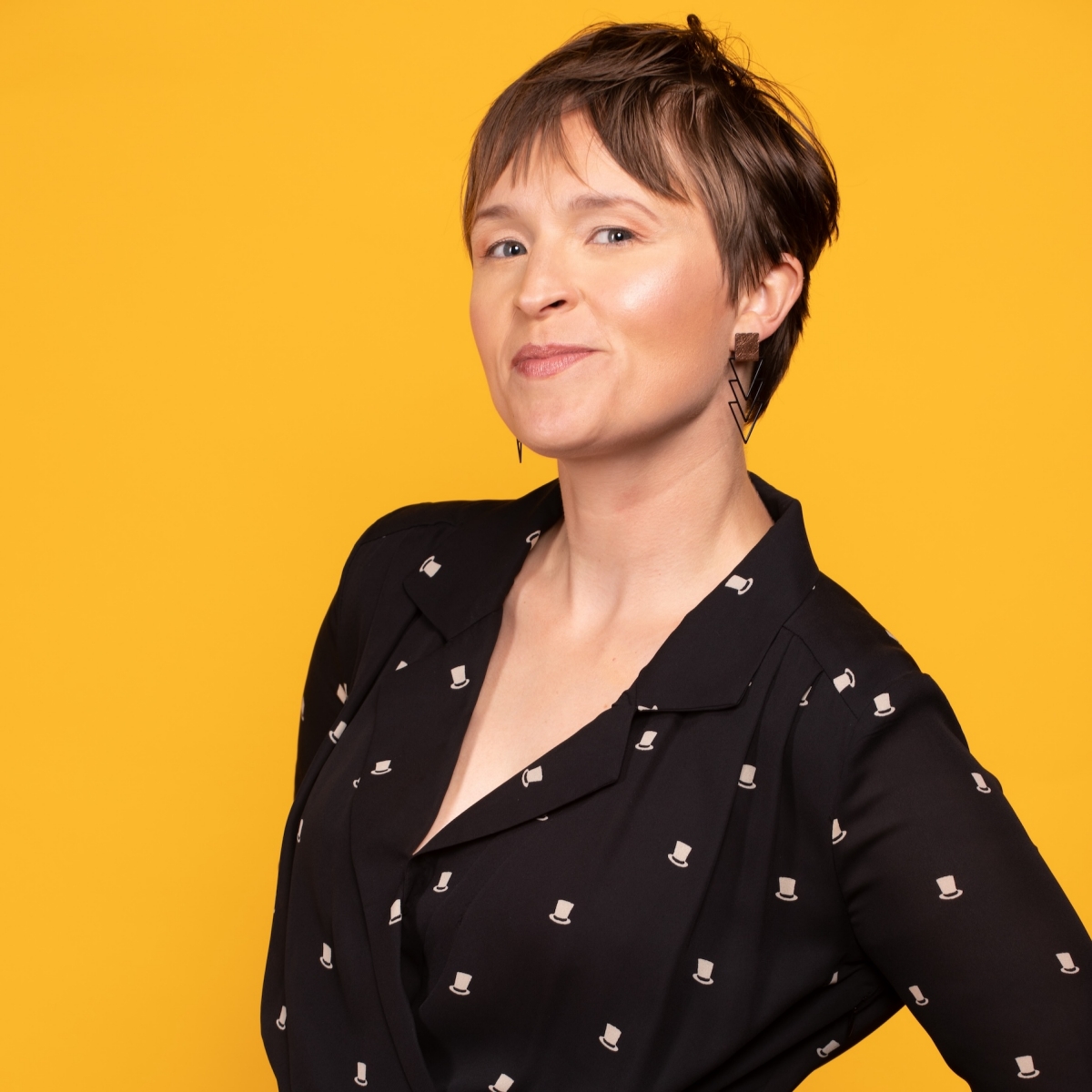 Headshot of Julia Proctor against yellow background