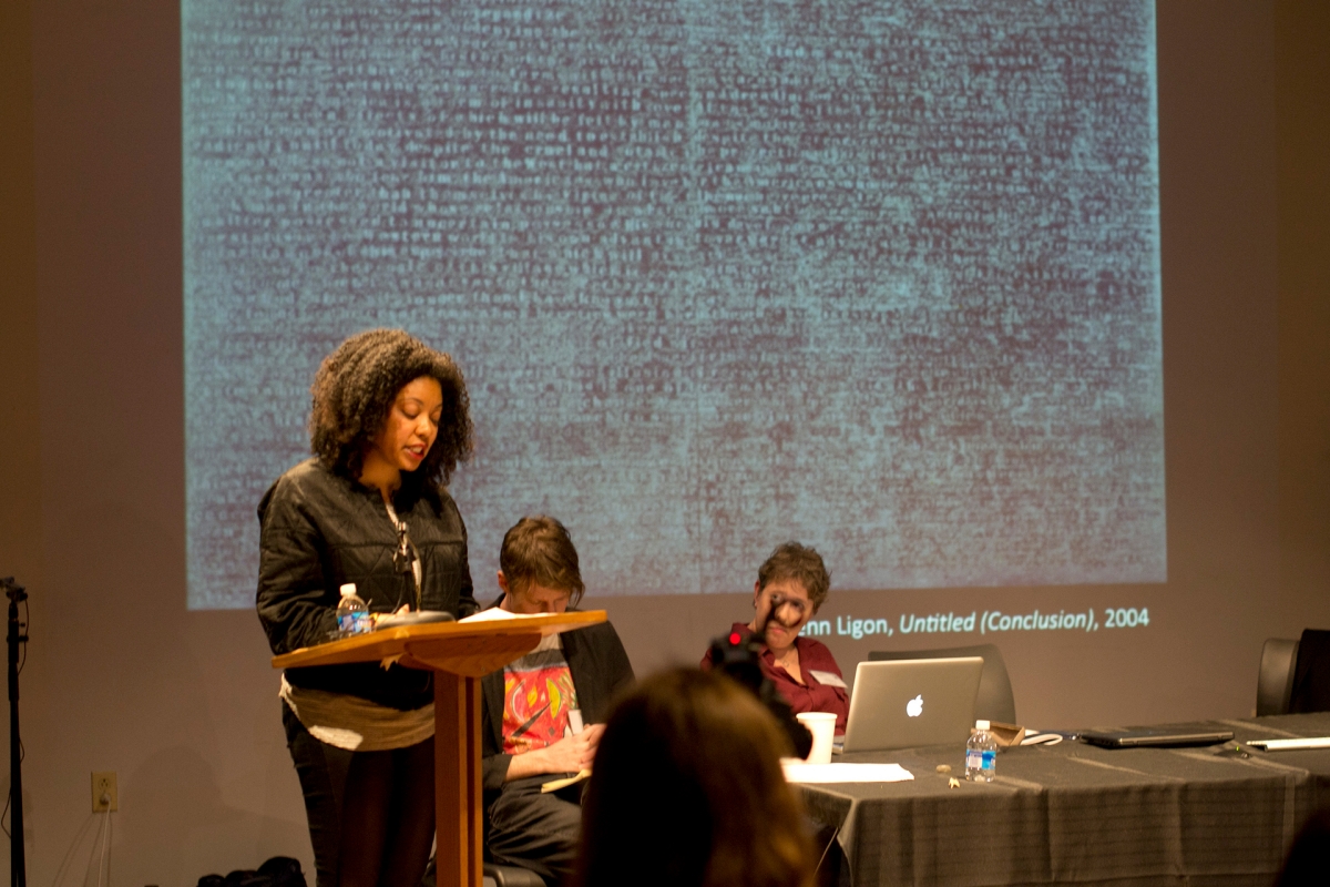 A lecture with screen in the background of fuzzy art