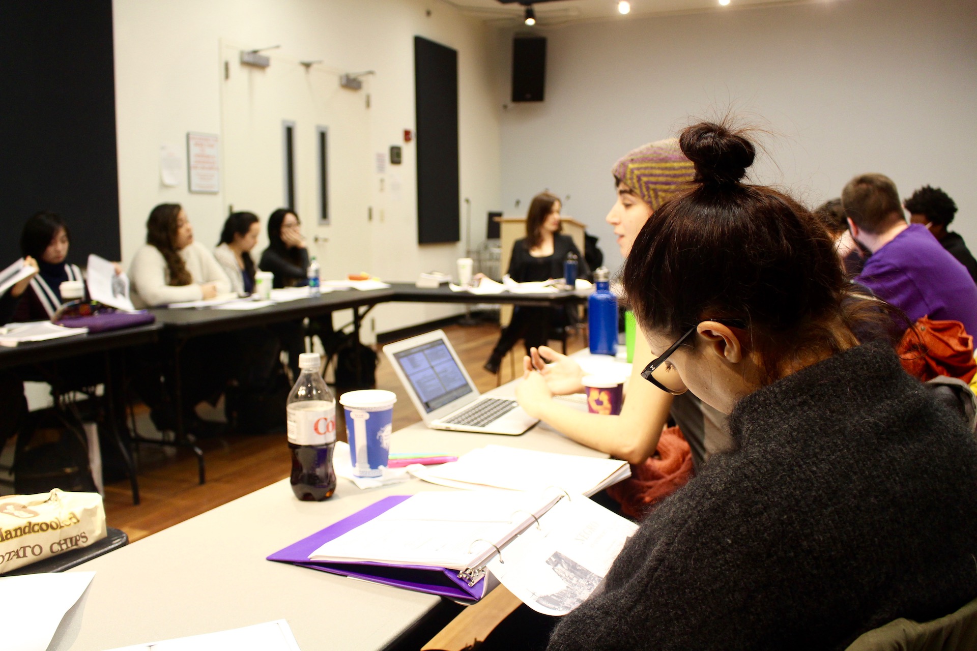 Student reading notes in classroom