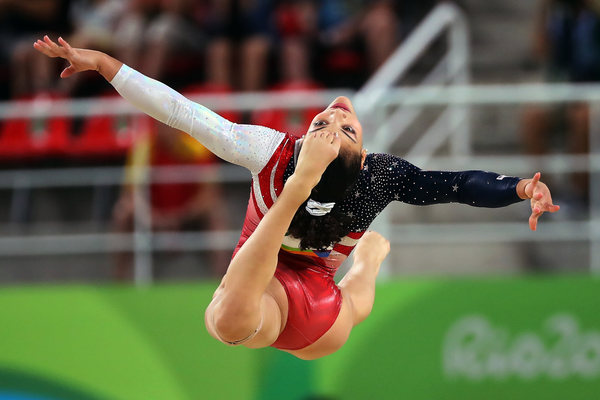 a female gymnast performs while leaping
