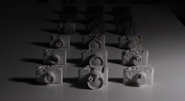 art installation depicting cameras lined up in three rows