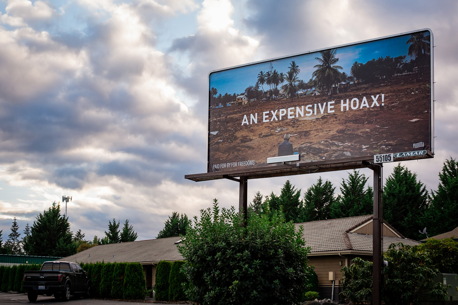 Billboard in town depicts "an expensive hoax" text 