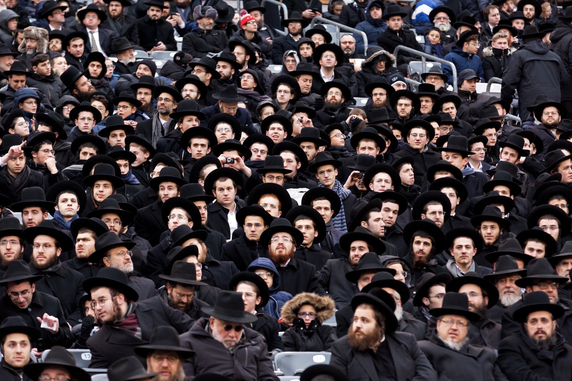 Celebrants packed the MetLife Stadium on Wednesday, some of the estimated 350,000 Jews all over the world who take part in the movement known as Daf Yomi. Jackson Krule for The New York Times