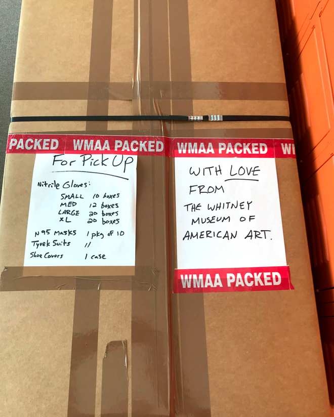 Boxes of donated medical supplies labeled "With Love, From The Whitney Museum of American Art"