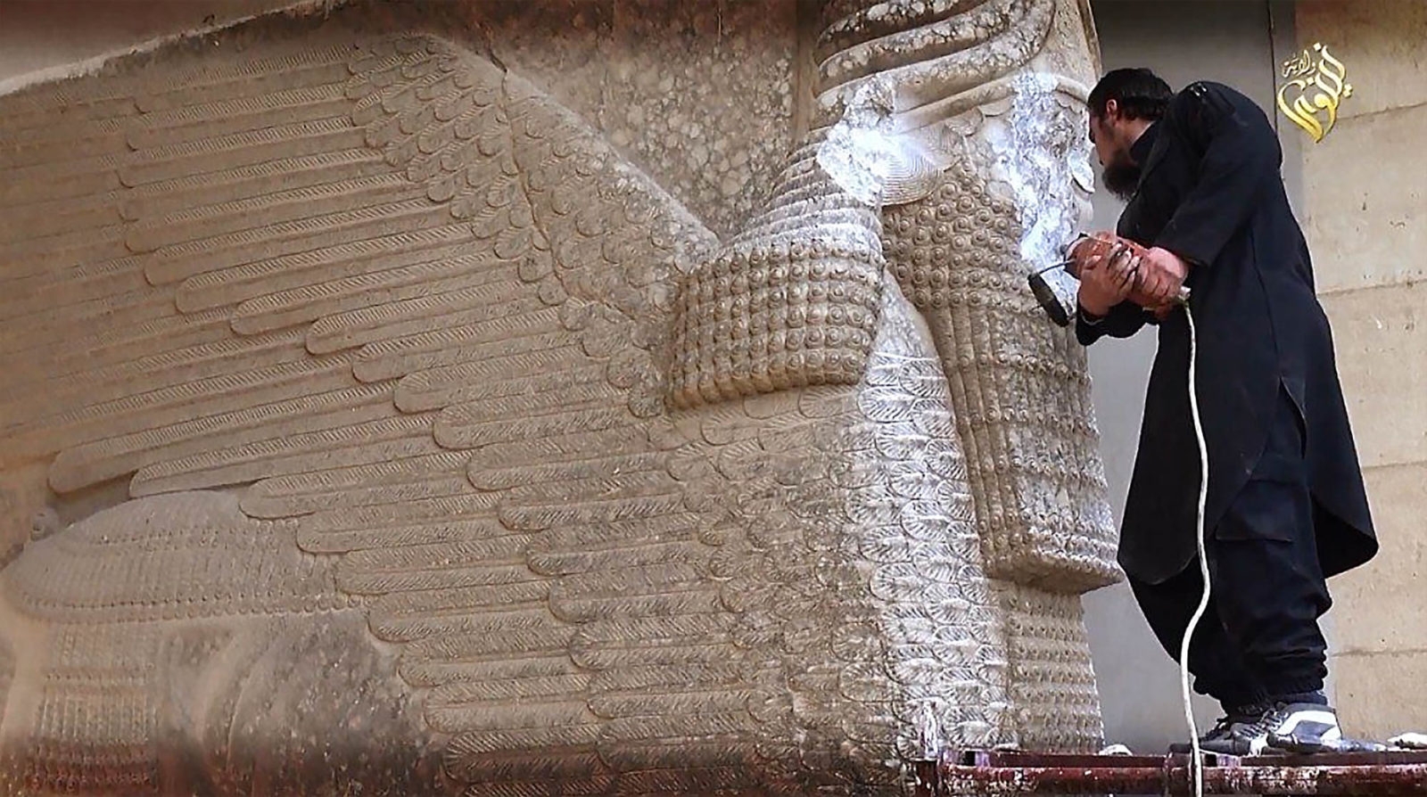 STILL FROM A 2015 ISStill from a 2015 ISIS propaganda video showing a member of the iconoclastic militant group wielding a jackhammer to chisel off the face of a nine-ton lamassu, a human-headed winged bull monument built in the 8th century B.C. to guard the Nergal Gate of the Assyrian city-state of Nineveh.