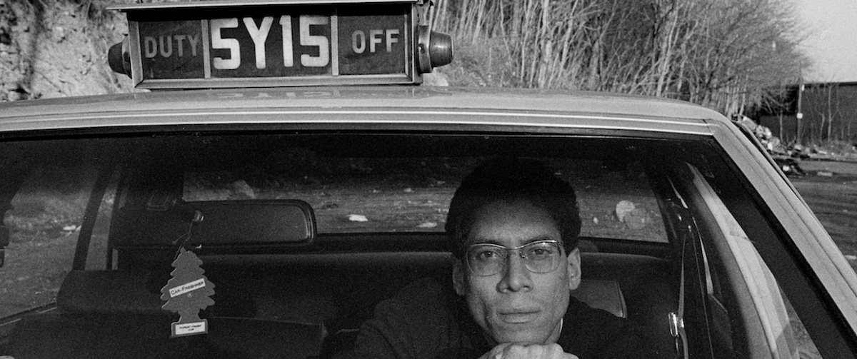 self portrait of the photographer joseph rodriguez sits in his taxi in 1970s looking onward