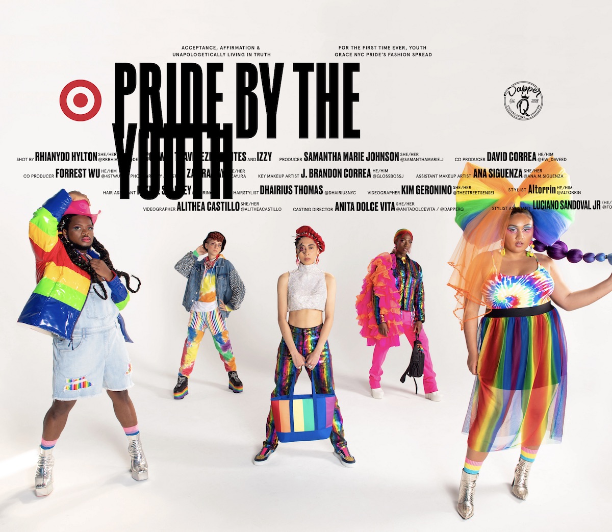 a studio portrait of five individuals posed and wearing pride colors and fashion
