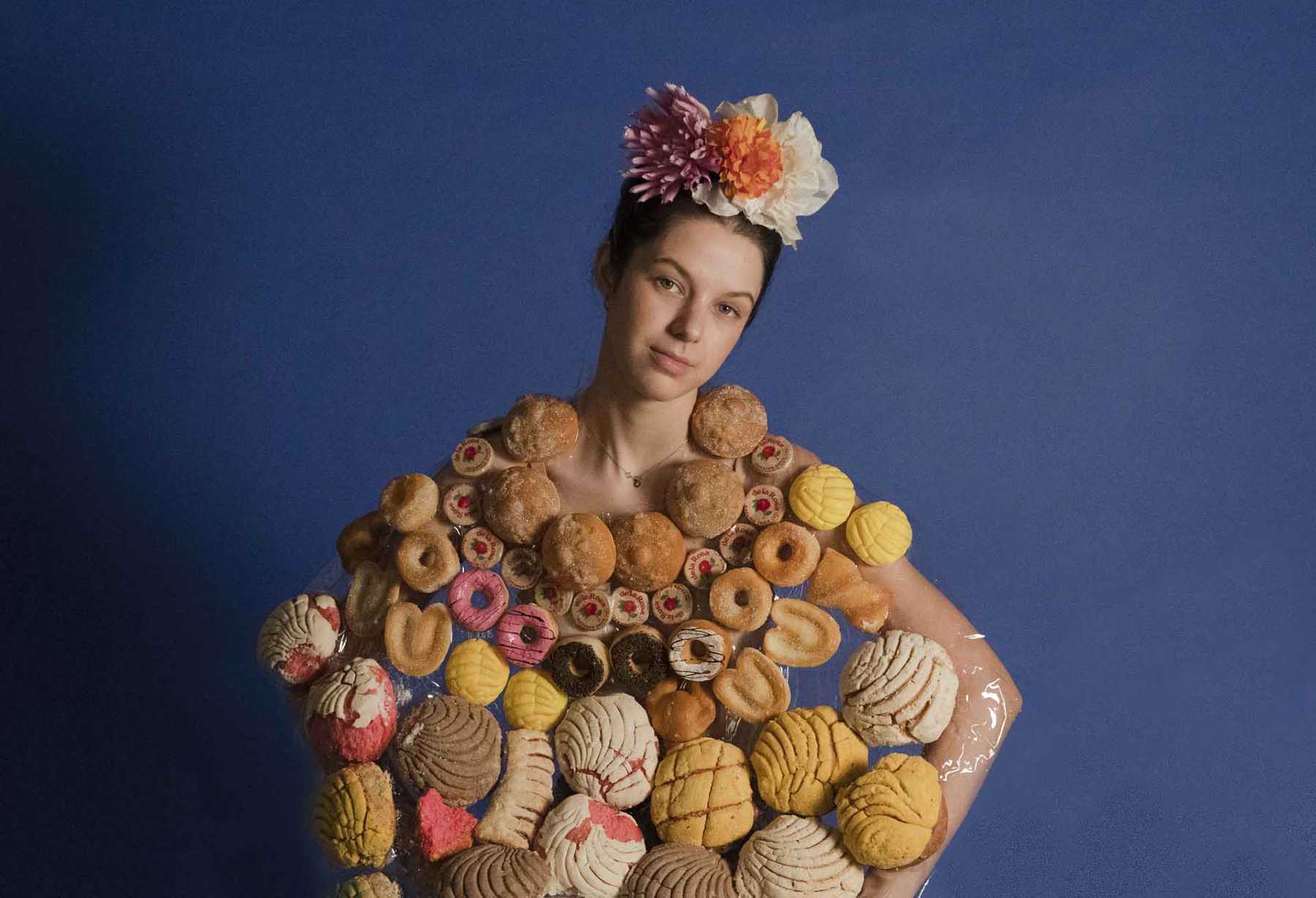 portrait insoired by frida khalo of a woman covered in sweet breads