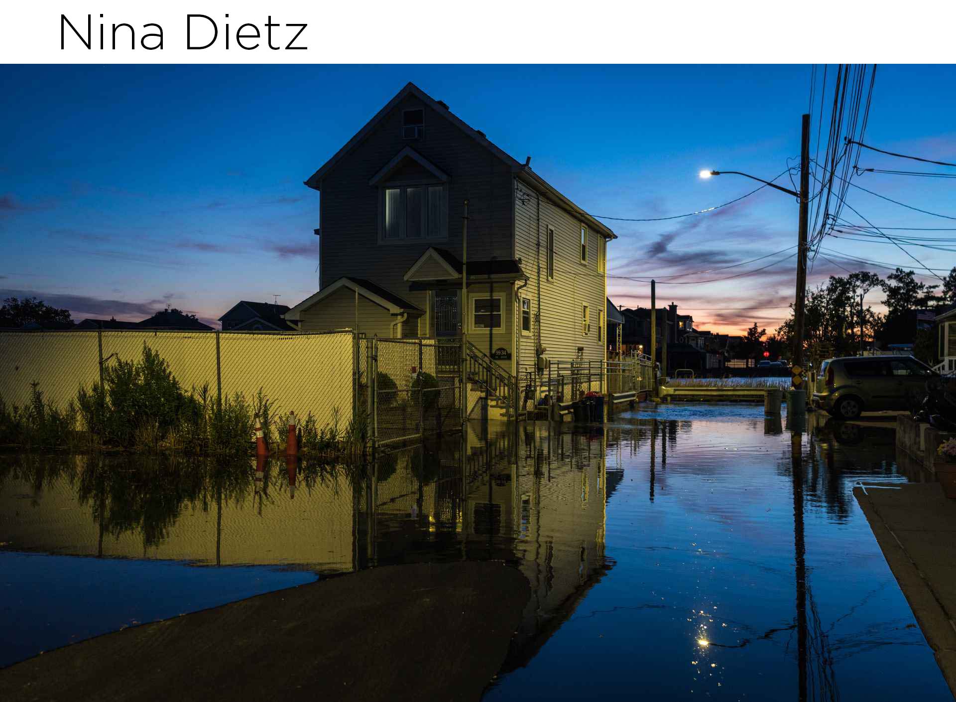 house and flooded street at sunset
