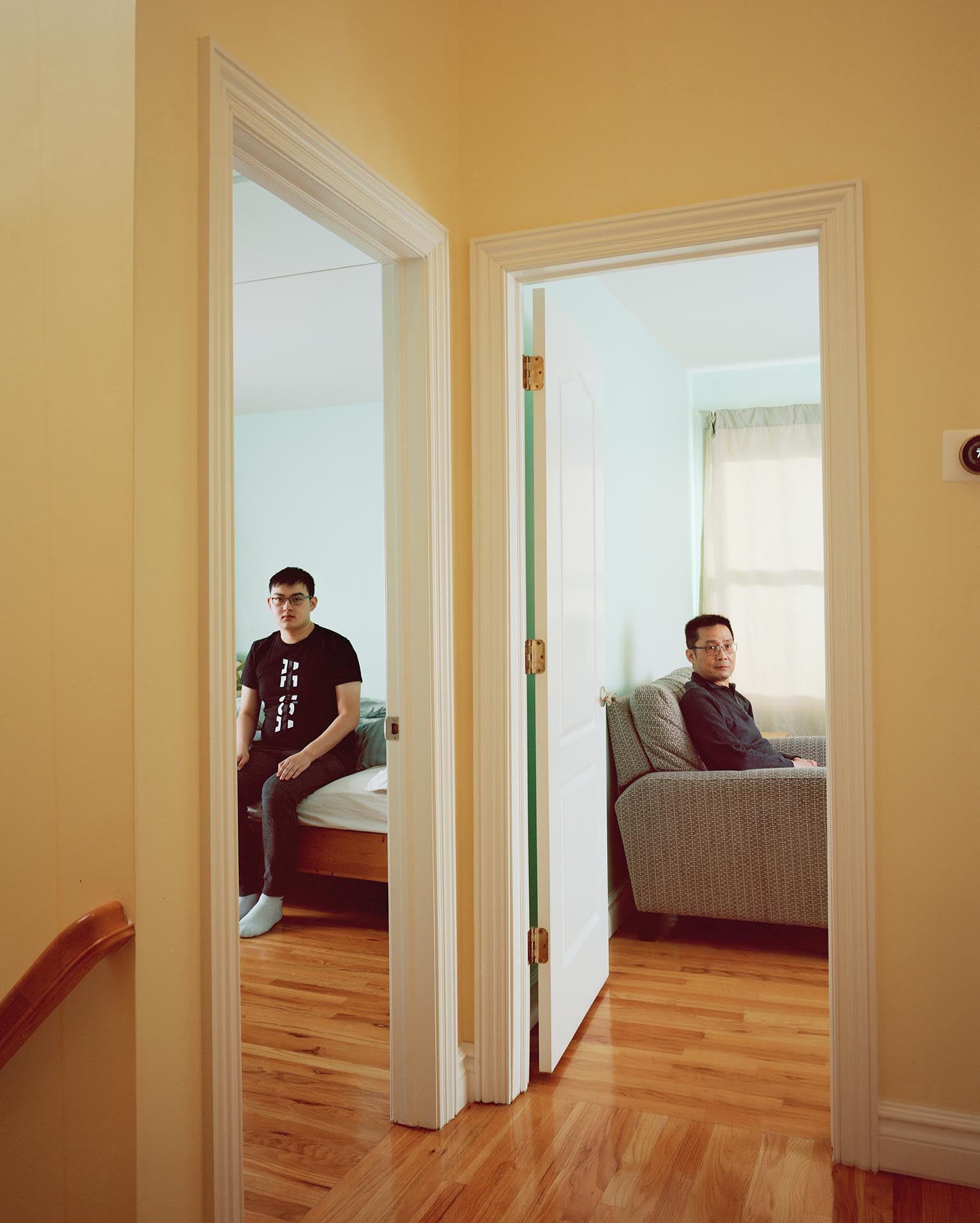people in separate rooms from hallway