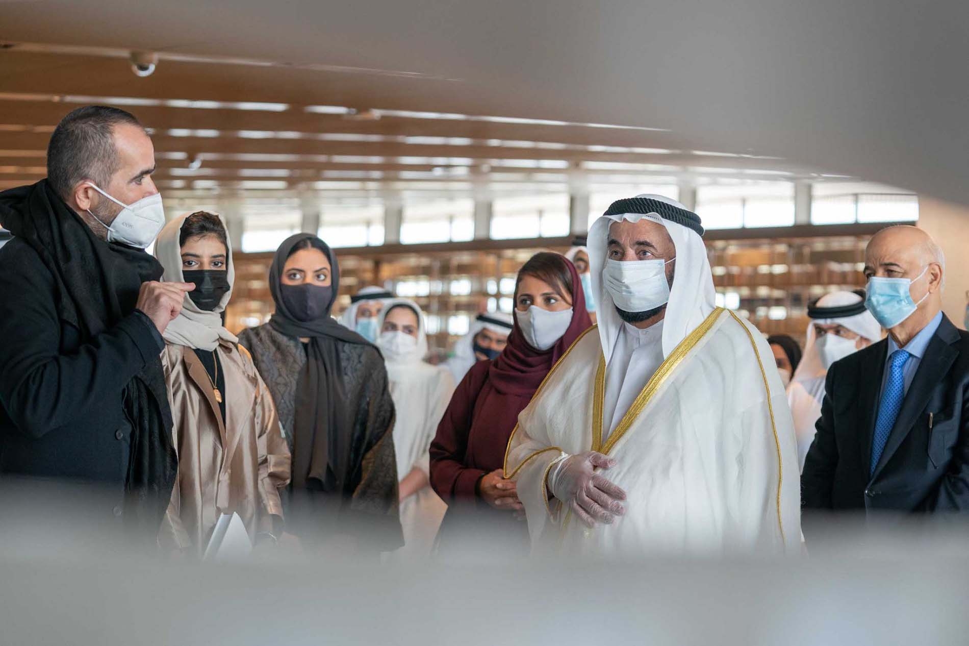 wafaa bilal presents artwork to masked crowd including Ruler of Sharjah